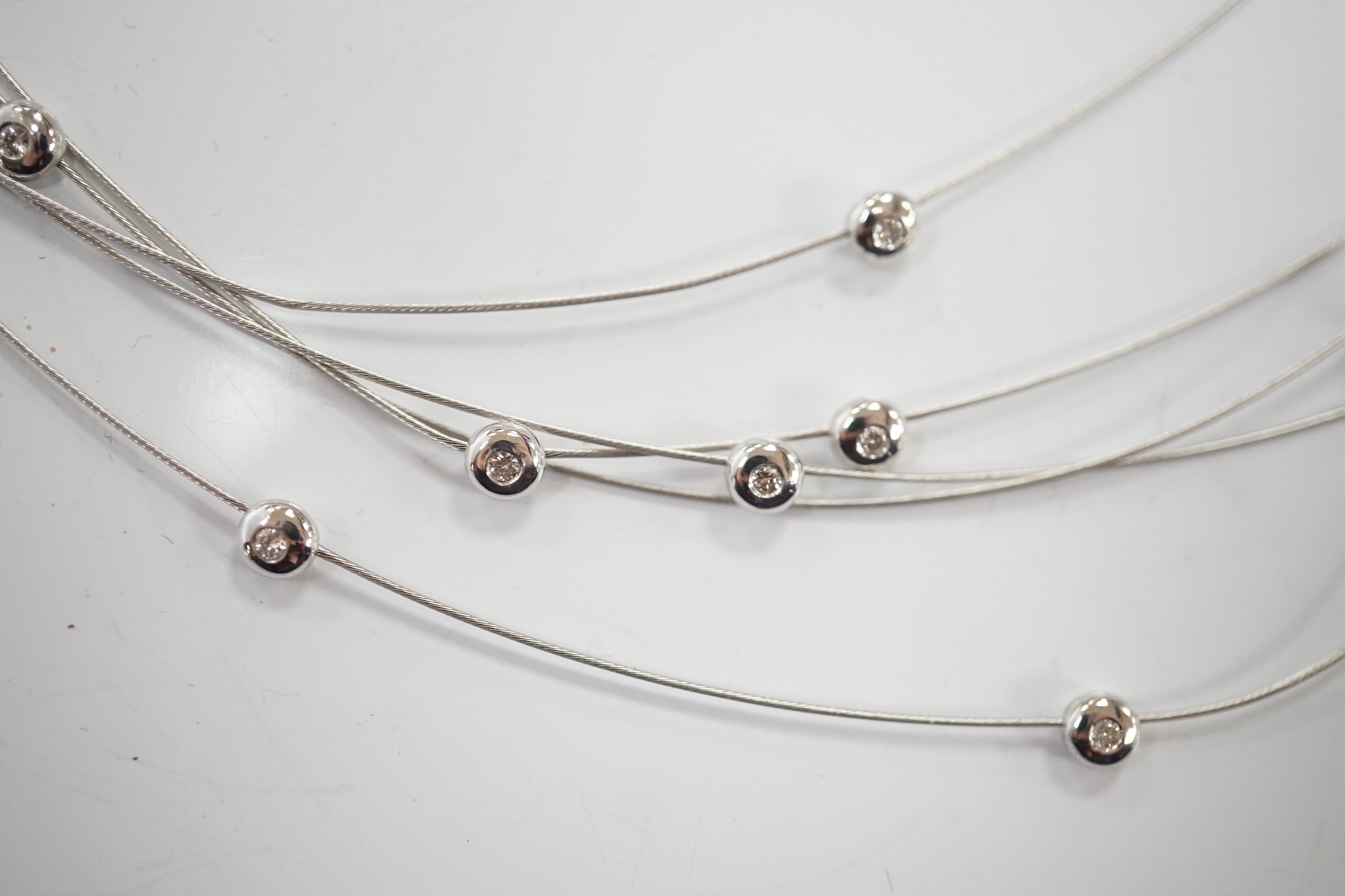 A modern Pruden & Smith silver and yellow metal hoop necklace and a 750 white metal and diamond set multi strand necklet retailed by Mappin & Webb. Condition - fair to good